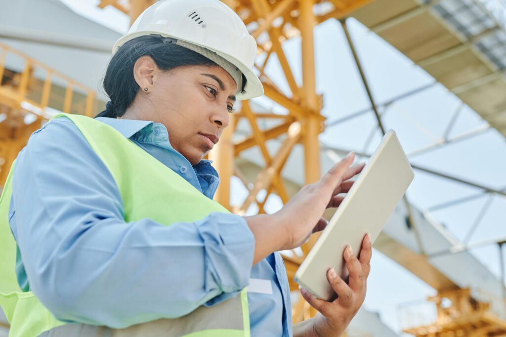 a female engineer in workwear checks her tablet on a construction site highlighting modern engineering practices 8960944 scaled