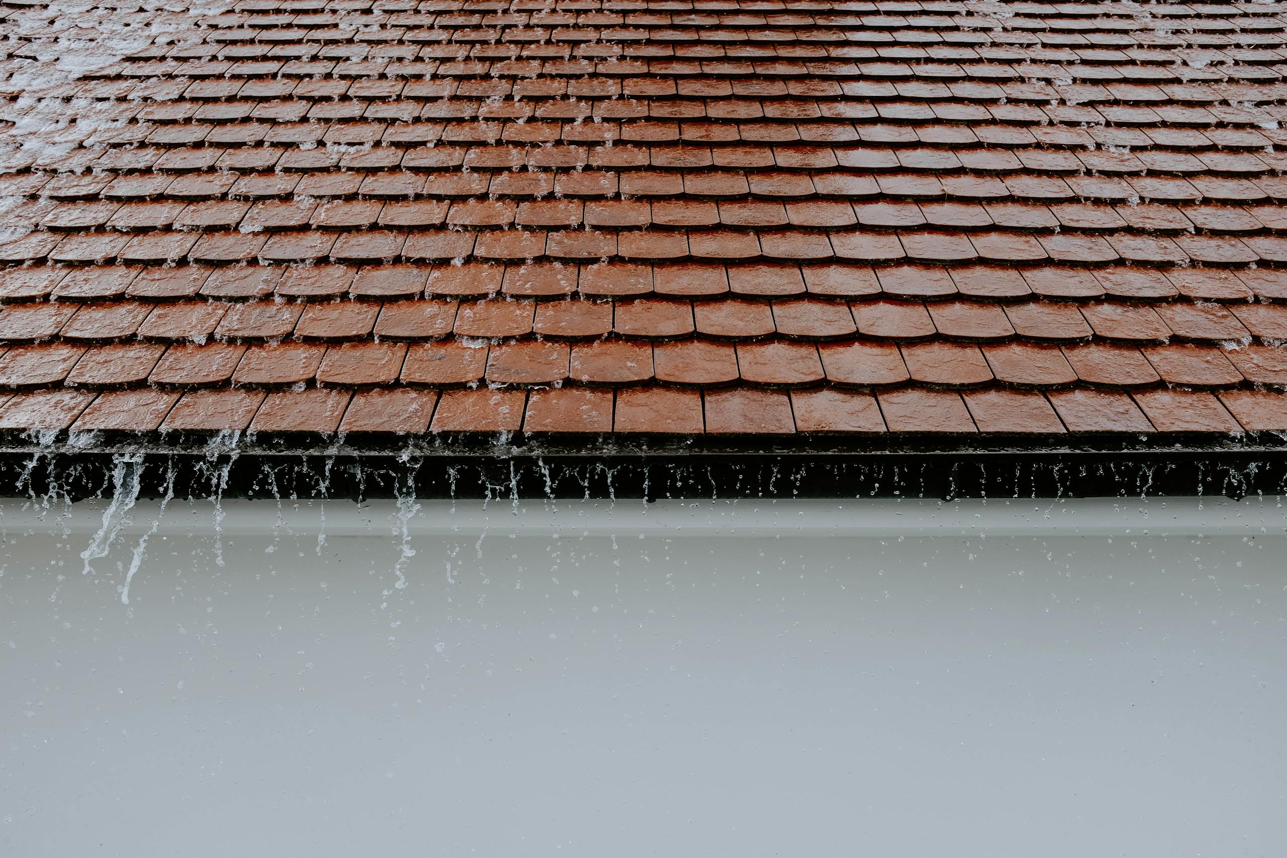 brown roof tiles with rainwater cascading down showcasing architectural texture and detail 2663254 scaled